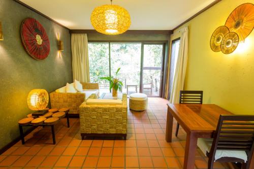a living room with a couch and a table at Namkat Yorla Pa Resort in Ban Kat