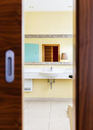 a bathroom with a sink and a mirror at Hotel Salzburg in Salzburg