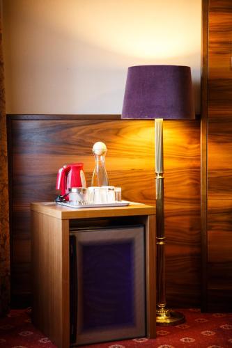a lamp sitting on top of a table with a sink at Hotel Salzburg in Salzburg