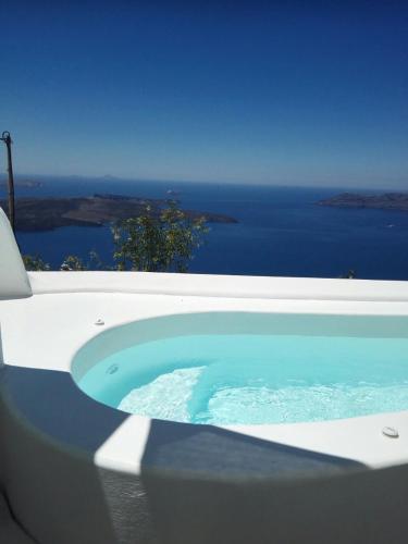 a bath tub with a view of the ocean at Native Eco Villas in Imerovigli