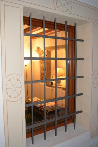 a room with a window with black bars at Alla Posta Guest House in Garna dʼAlpago