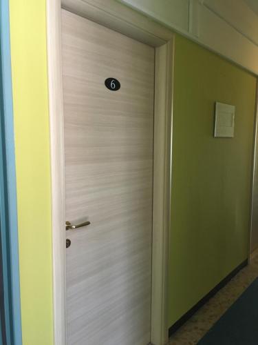 a door in a room with a thermometer on it at Hotel San Marco BB in Boario Terme