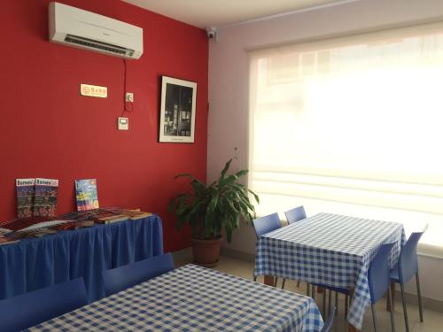 a dining room with two tables and a window at Raja Inn in Miri