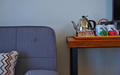 a table with a tea kettle on top of a table at Yulaikung B&B in Yongan