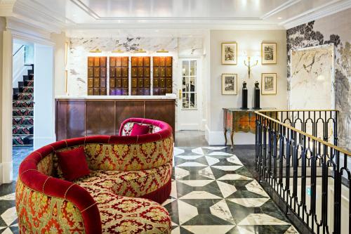 a living room with a chair and a counter at Relais Christine in Paris