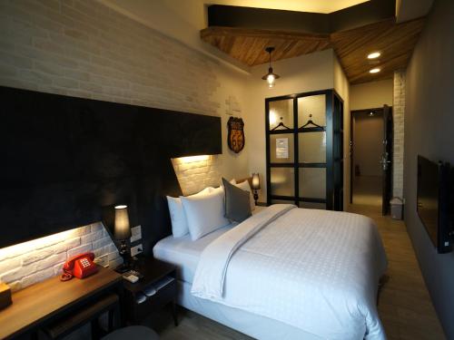 Ένα ή περισσότερα κρεβάτια σε δωμάτιο στο Kenting Moon Bay Hotel