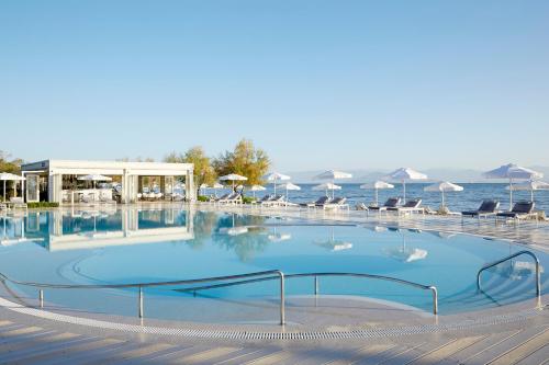 
a swimming pool with a large pool of water at Mayor Capo Di Corfu in Kavos
