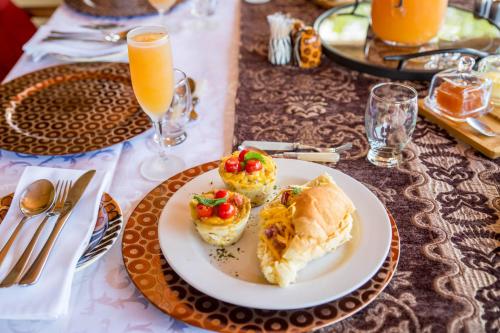 a table with a plate of food on a table at Boubou Bed and Breakfast in Rustenburg