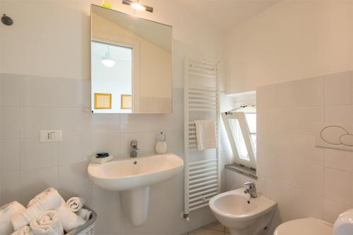 a bathroom with a sink and a toilet and a mirror at Agriturismo Pian di Spille - Golf in Tarquinia