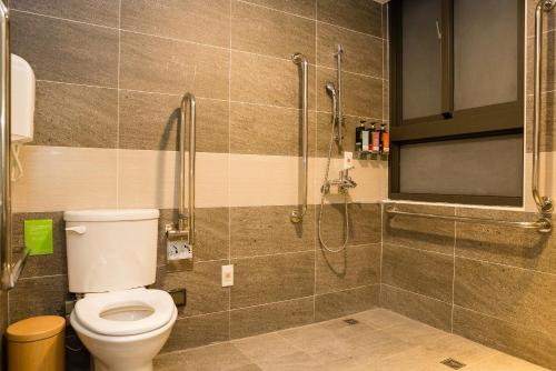a bathroom with a toilet and a shower at V-Hotel in Taitung City