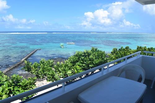 a balcony with a view of the ocean at Blue Beryl Guest House in Blue Bay