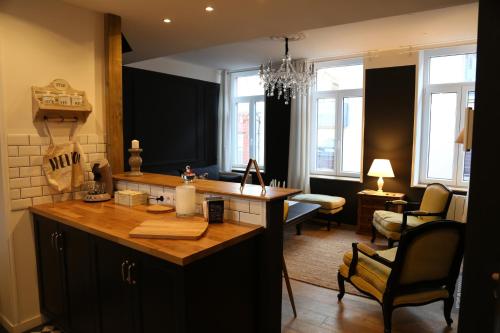 a kitchen with a island in the middle of a room at L'archipel in Lille