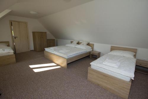 a room with two beds in a attic at Chalupa pod Hruškou in Zubří