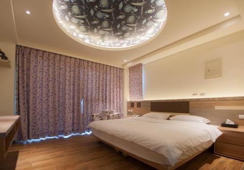 Postel nebo postele na pokoji v ubytování So Lohas B&B