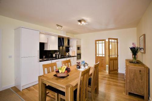 a kitchen and dining room with a table and chairs at Croft Mill in Hebden Bridge
