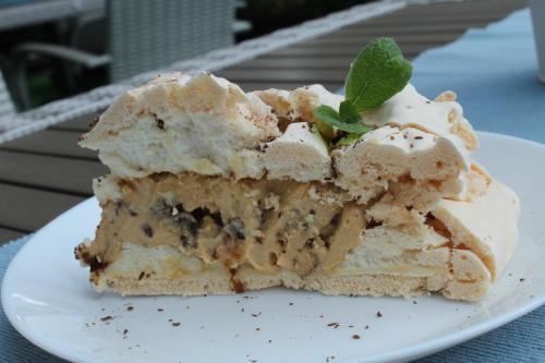 a piece of cake on a plate on a table at Dom Przy Plaży in Sarbinowo