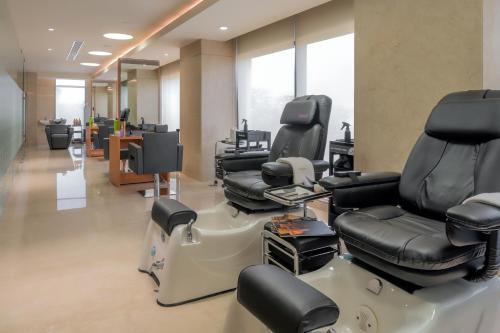 a hair salon with chairs and a barber shop at Feathers- A Radha Hotel, Chennai in Chennai