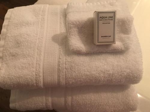 a white towel with a sign on top of it at B&B Number 11 Exclusive Guesthouse in Bruges