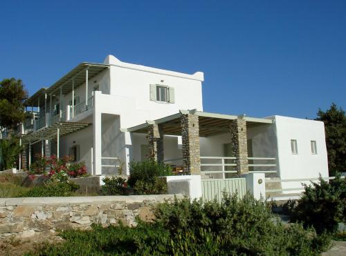 a white house with a fence in front of it at Mike'sPlace in Antiparos Town