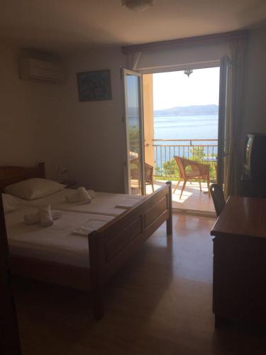 a bedroom with a bed and a door to a balcony at Villa Luka in Brela