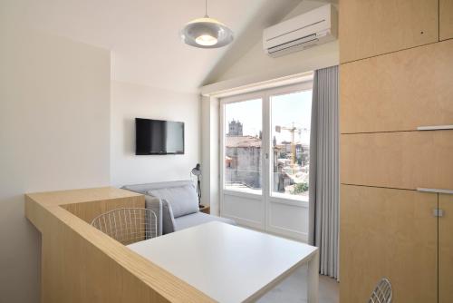 a small room with a table and a window at House of Artists in Porto