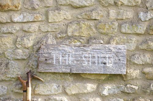 a sign on the side of a stone wall at The Wheatsheaf Combe Hay in Bath