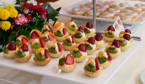 a tray of fruit cupcakes with fruit on top at Hotel Srní a Depandance in Srní
