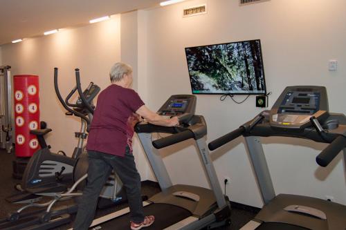 a man exercising on a treadmill in a gym at Hotel Srní a Depandance in Srní