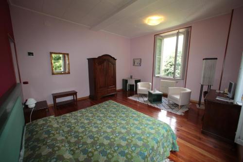 1 dormitorio con cama, escritorio y ventana en Hotel Valganna - Tre Risotti, en Valganna