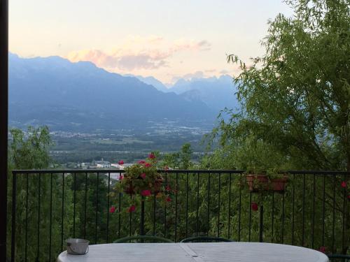 a balcony with a table and a view of mountains at Casa Rosetta in Mel
