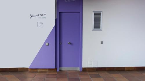 a purple door in a building with a tile floor at Jacarandas Beach in Playa del Ingles