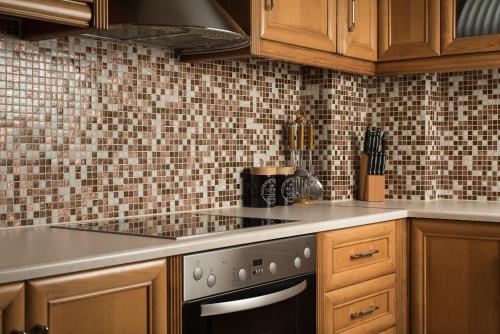 a kitchen with wooden cabinets and a stove top oven at Villa Ira in Chorafakia