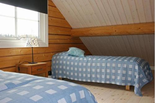 Säng eller sängar i ett rum på Rensbo Stugor