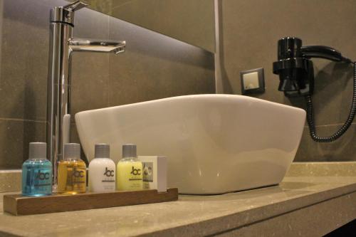 a bathroom sink with a soap dispenser next to it at BC Pangaldi in Istanbul