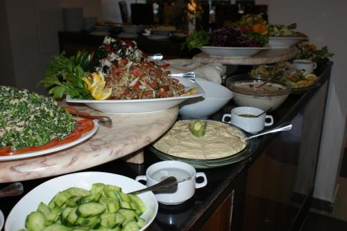 a buffet with many plates of food on a table at La Maison Hotel in Wadi Musa