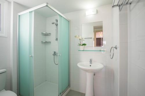 a bathroom with a glass shower and a sink at Christabelle Hotel Apartments in Ayia Napa