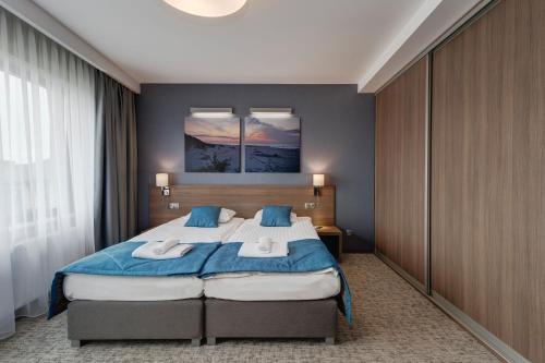 Кровать или кровати в номере WIND Hotel