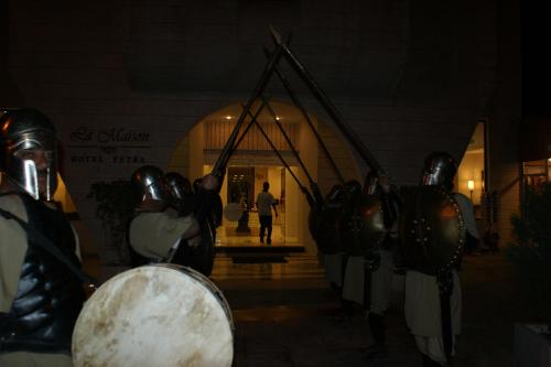 a group of people wearing armor standing in front of a building at La Maison Hotel in Wadi Musa