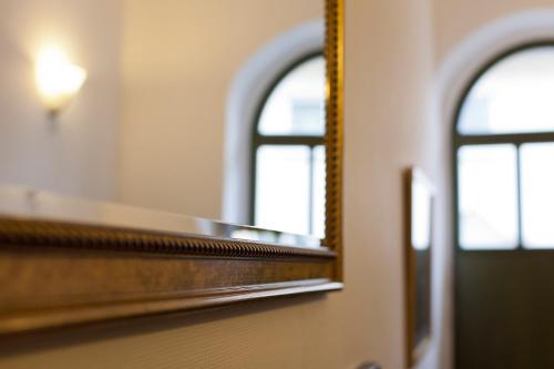 a mirror on a train with two windows at Hotel Gruenshof in Walldorf