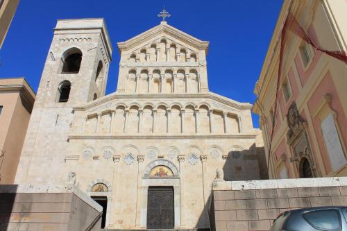 a church with a tower and a clock tower at Fede & Francy in Quartu SantʼElena