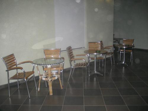 a group of tables and chairs in a room at Guest House Vila Mimoza in Ulcinj