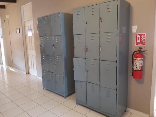 a row of lockers in a room with a fire extinguisher at Managua Backpackers Inn in Managua
