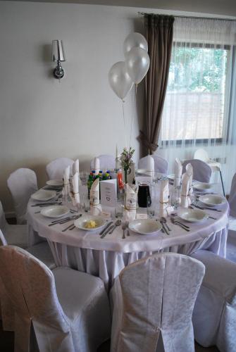 a white table with white chairs and a balloon at Dwa Bratanki in Rzeszów