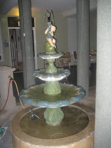 a green fountain with a mouse on top of it at Guest House Vila Mimoza in Ulcinj