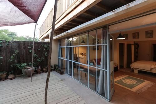 a patio with sliding glass doors on a house at Krivine B&B in Midreshet Ben Gurion