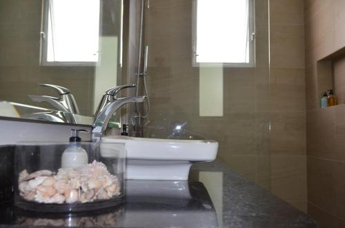 a bathroom with a sink and a toilet at Luxury Private Villas , Private Pool, Private garden, Jacuzzi, 24hours security in Tulum