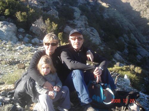 a man and a woman and a child sitting on a mountain at Résidence E CIME ASCO in Asco