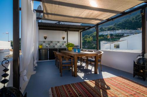 a table and chairs on a balcony with a view at Boutique Hotel La Posada del Angel Ojén in Ojén