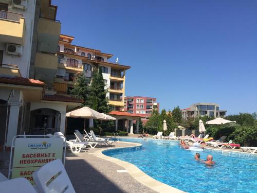 a swimming pool with people in a hotel at Studio Apartment C32 in Dream Holiday Complex Ravda in Ravda
