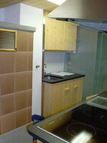 a kitchen with a sink and a stove top oven at Chalet Weidli in Achseten